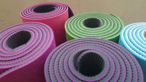 Yoga mats lined up next to each other.